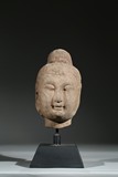 A STONE CARVED HEAD OF BUDDHA