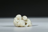 A WHITE JADE CARVING OF MONKEYS AND PEACH