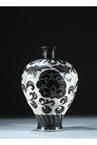 A BRONZE WHITE GROUND BLACK FOLIATE SCROLL DECORATED VASE