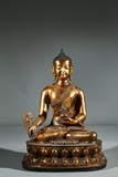 A GILT BRONZE FIGURE OF BHAISAJYAGURU