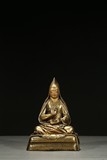 A GILT-BRONZE FIGURE OF LAMA