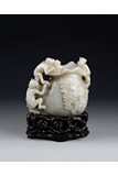 A WHITE JADE CARVED 'MONKEYS AND BAG' VASE