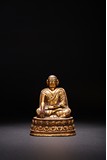 A GILT BRONZE FIGURE OF LAMA