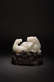 A CHINESE WHITE JADE CARVING OF HORSE GROUP WITH STAND