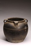 A LARGE BLACK GLAZED POTTERY JAR
