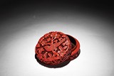 A CINNABAR LACQUER CARVED CIRCULAR BOX AND COVER