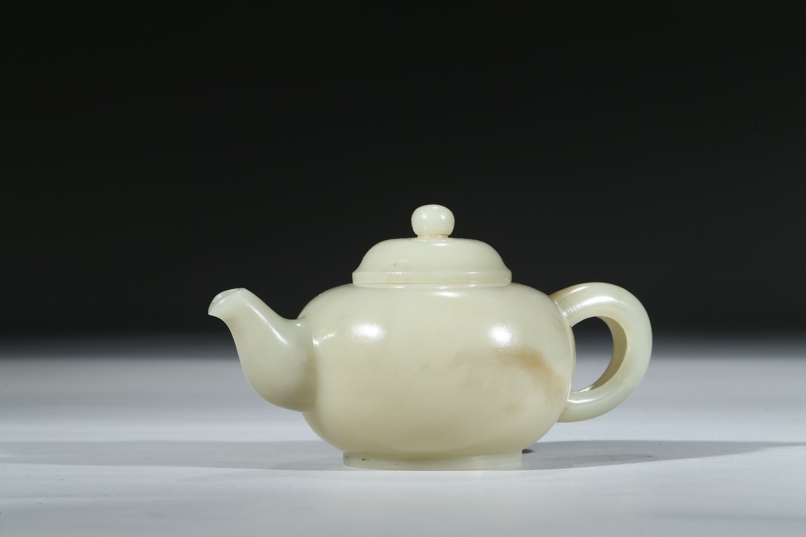 A WHITE JADE CARVED TEAPOT AND COVER
