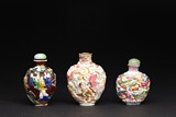 A GROUP OF THREE CARVED FAMILLE ROSE SNUFF BOTTLES