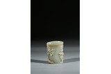 A SMALL CELADON JADE 'BAMBOO AND PRUNUS' BRUSHPOT