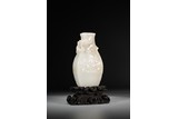 A WHITE JADE CARVED 'DRAGON & TAOTIE' VASE WITH STAND