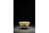 A CHINESE YELLOW GROUND FAMILLE ROSE 'BUDDHIST MOTIF' BOWL