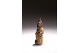 A JADE CARVED KNEELING FIGURE