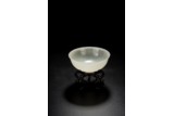 A WHITE JADE CARVED BOWL WITH HARDWOOD STAND