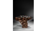 A CHINESE ALOESWOOD CARVED 'LANDSCAPE' LIBATION CUP