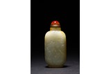 A WHITE AND RUSSET JADE SNUFF BOTTLE