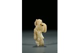 A WHITE JADE CARVING OF FIGURES