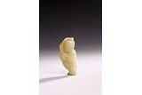 A WHITE JADE CARVING OF BOY HOLDING LOTUS