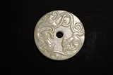 A CHINESE WHITE JADE 'CHILONG' BI DISC