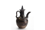 A BLACK GLAZED EWER