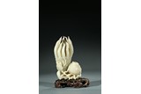 A CHINESE WHITE JADE CARVING OF BUDDHA'S HAND