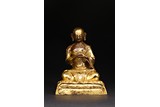 A GILT BRONZE FIGURE OF ARHAT