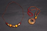 A GROUP OF TWO ARCHAIC JADE DISC AND NECKLACE