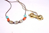 A DZI BEAD NECKLACE AND GILT BRONZE VAJRA