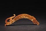 AN ARCHAIC BEIGE AND YELLOW JADE 'DRAGON' PENDANT