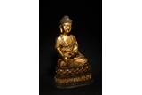 A GILT BRONZE FIGURE OF SHAKYAMUNI
