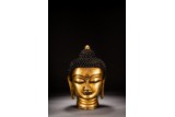 A GILT BRONZE HEAD OF SHAKYAMUNI 