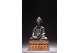 A HARDWOOD CARVED FIGURE OF SHAKYAMUNI WITH STAND