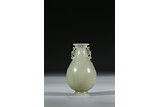A CELADON JADE CARVED VASE 