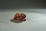 AN ARCHAIC AMBER CARVING OF RABBIT