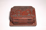 A CINNABAR LACQUER 'FIGURES' BOX AND TRAY