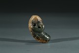A GREEN JADE FIGURAL PENDANT