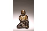 A CHINESE BRONZE FIGURE OF SEATED ARHAT
