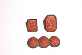 A GROUP OF CINNABAR LACQUER RINGS AND BROOCHES
