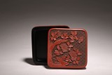 A CINNABAR LACQUER FLOWERS SQUARE BOX AND COVER