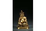 A TIBETAN GILT BRONZE FIGURE OF JAMBHALA