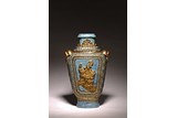 A GILT DECORATED BRONZE IMITATION RELIEF FIGURES VASE