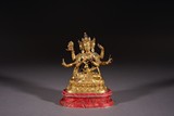 A GILT BRONZE FIGURE OF SEATED USNISA VIJAYA