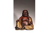 A CHINESE GILT LACQUERED FIGURE OF SEATED BUDAI