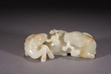 A CHINESE CELADON JADE RAMS