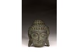 A CHINESE PATINATED BRONZE BUDDHA HEAD