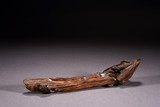 A NATURALISTIC AGARWOOD CARVED HORIZONTAL RAFT 