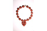 A CINNABAR LACQUER 'LONGEVITY' BEAD BRACELET