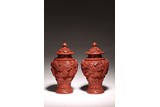 A PAIR OF CINNABAR LACQUER VASES AND COVERS