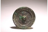 AN ARCHAIC CHINESE BRONZE MIRROR 
