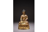 A PARCEL GILT BRONZE FIGURE OF SHAKYAMUNI 