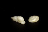 A GROUP OF TWO WHITE JADE TOGGLES